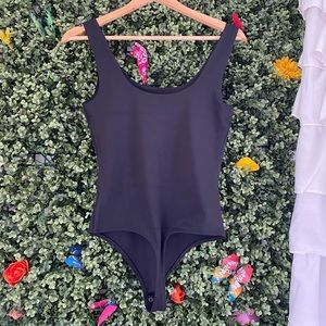 Express Body Contour Scoop Neck Thong Bodysuit in color pitch black